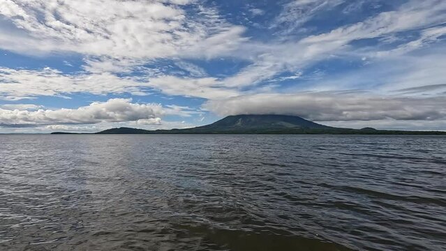 Ometepe Island, Nicaragua timelapse. Timelapse showing one of two volcanos of Ometepe island. Clouds flow fast over a big green volcano in Central America. Mountain clouds' time lapse.  