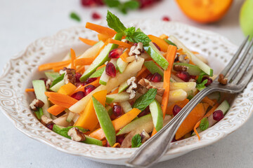 Carrot,quince,persimmon and apple salad with dressing.	