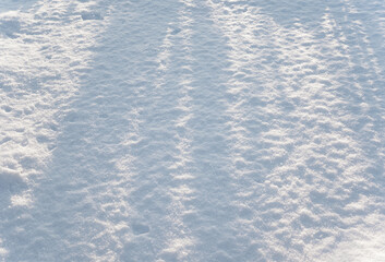 Abstract background of snow cover in the rays of the sun