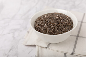 Fototapeta na wymiar Chia seeds in a bowl on a white textural background. Superfood. Healthy food. Diet. The concept of proper nutrition. antioxidant. Place for text, space for copy.