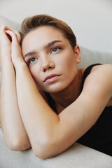 Fototapeta premium Young woman with short haircut hair having fun at home on the couch smile and happiness, vacation at home, natural posing without filters, free copy space
