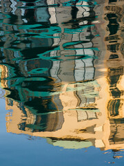 Background. Texture. Abstraction. Reflections of colorful buildings in Spinola Bay. St Julian, Malta. Europe.