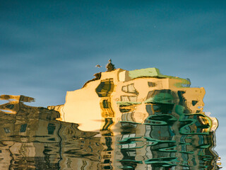 Background. Texture. Abstraction. Reflections of colorful buildings in Spinola Bay. St Julian, Malta. Europe.