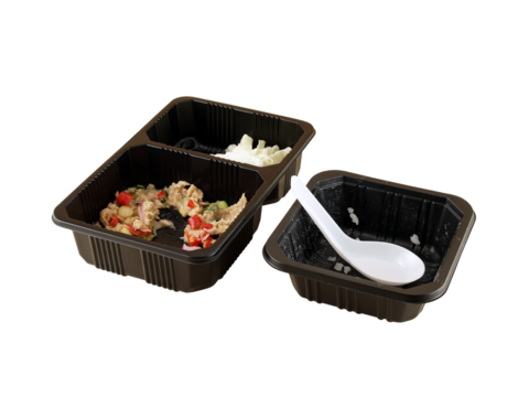 few grain of steamed rice with white plastic spoon in black plastic deep tray and spicy tuna salad in two hole plastic tray isolated on white background, food waste in disposable microwave containers