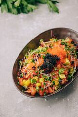 salad with salmon and red and black caviar