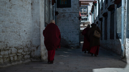 Obraz na płótnie Canvas Tibet, Lhasa, China, People walking along the ancient Barkhor street Bakuo W street in summer day in cloudy we