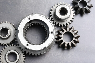 Different stainless steel gears on grey background, flat lay