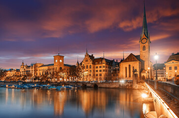 Fototapeta na wymiar Incredible picturesque sityscape. Panoramic view of famous Fraumunster church, Munsterbrucke bridge and river Limmat with colorful sky during sunset.Zurich is Popular travel destination