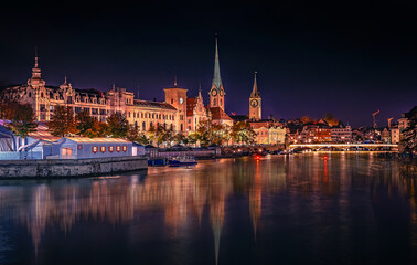 Evening panoramic view of historic Zurich city center with famous Fraumunster and river Limmat at Lake Zurich. Cityscape image of Zurich with reflection. Switzerland