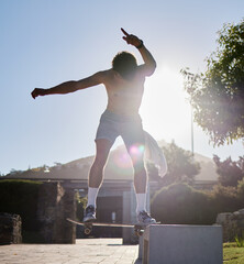 Skateboard, ramp and young man doing a trick at an outdoor park for fun, fitness or training....