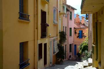 Fototapeta na wymiar Street of a mediterranean town. Multicolored houses. Narrow street.