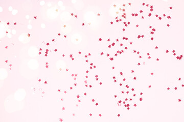 Christmas flat lay scene with scattered stars, top view over pink