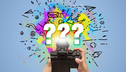 Close-up of a hand holding digital camera with abstract drawing concept