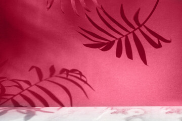 Minimal modern product display of gray stone on viva magenta background with palm leaves and shadow overlay
