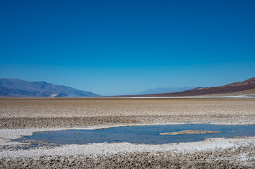 Detail of a puddle or water mirage in the hot Mojave desert