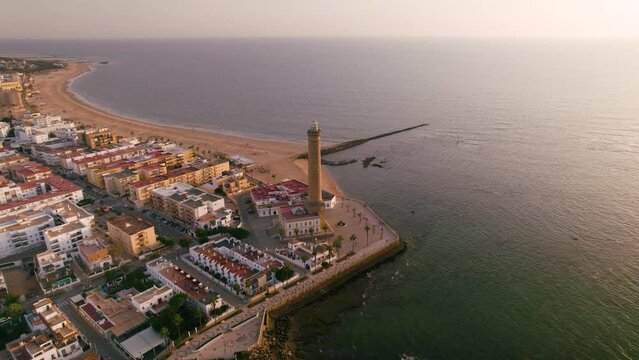 Sky view of the beautiful city Chipiona flying a drone, in the province of Cadiz (Andalucia, Spain). In the shot is shown Chipiona's lighthouse at the coast, and typical andalusian small white houses.