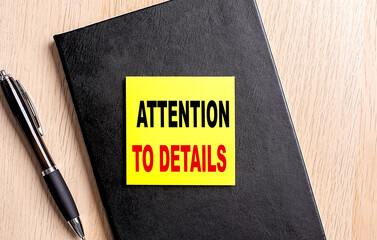ATTENTION TO DETAILS text on white paper. the inscription on the notebook