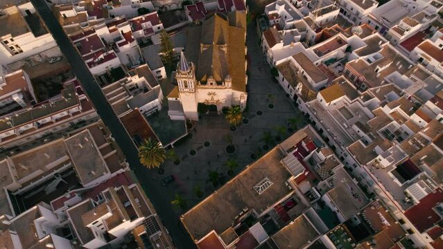 Sky view of the city Chipiona flying a drone, in the province of Cadiz (Andalucia, Spain). In the shot is shown the cathedral 'Nuestra senora de la O', and typical andalusian small white houses.