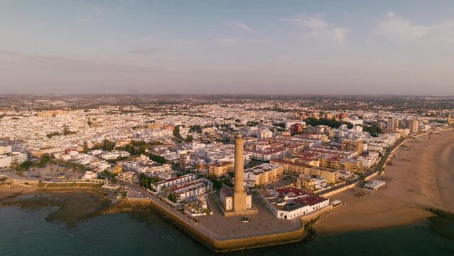 Sky view of the beautiful city Chipiona flying a drone, in the province of Cadiz (Andalucia, Spain). In the shot is shown Chipiona's lighthouse at the coast, and typical andalusian small white houses.
