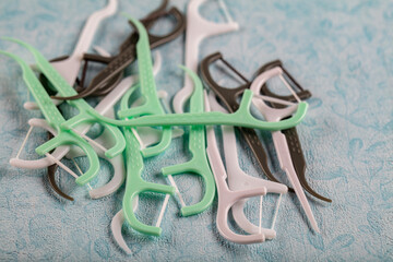 Colorful toothpick. Assorted colors dental floss pick on the color background.