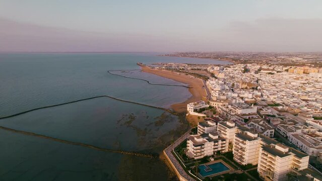 Sky view of the beautiful city Chipiona flying a drone, in the province of Cadiz (Andalucia, Spain). In the shot is shown Chipiona's coast, 'corrales de Chipiona' (fishing pens of Chipiona)