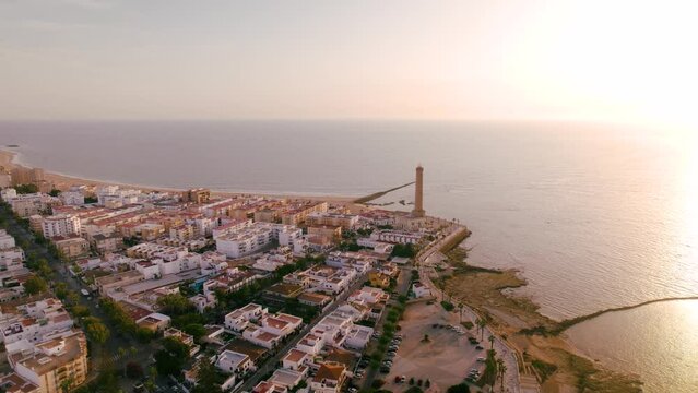 Sky view of the beautiful city Chipiona flying a drone, in the province of Cadiz (Andalucia, Spain). In the shot is shown Chipiona's lighthouse at the coast, and typical andalusian small white houses.