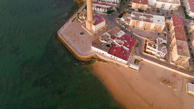 Sky view of the beautiful city Chipiona flying a drone, in the province of Cadiz (Andalucia, Spain). In the shot is shown Chipiona's lighthouse at the coast, and typical andalusian small white houses.