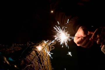  sparklers. father sharing with his daughter the fire of gunpowder sparks. christmas celebration. gunpowder. december 7. butterfly sparklers. new year's eve parties in latin america. 