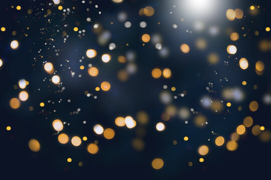 Abstract gold and silver christmas bokeh on dark blue background.