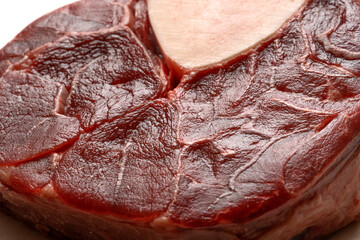 Raw steak on baking paper in the kitchen