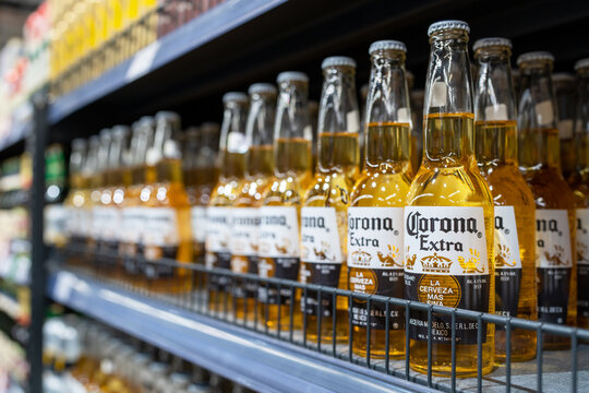 Corona extra beer bottles on shelves in a supermarket. Corona Extra is a pale lager produced by Cervecería Modelo in Mexico. Minsk, Belarus, 2022