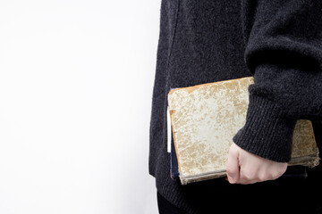 hands hold old books with textured paper and torn cover. vintage paper texture. selective focus....