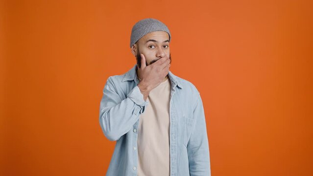 Young bearded man places hand across face in frustration