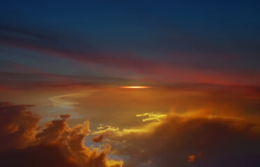   orange sunse on night blue sky dramatic clouds and sun flares , nature seascape 