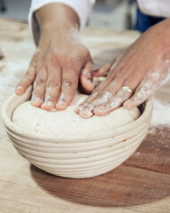 Kneading and preparation of sourdough-based bread. On a wooden table. in bakery
