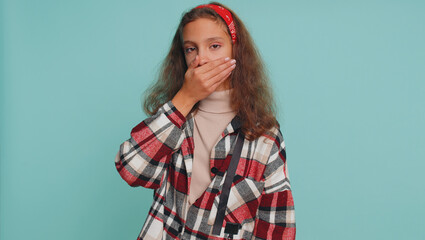 I will not say anything. Frightened shocked teenager child girl kid closing her mouth with hand,...