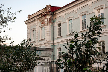 Old city buildings with ancient windows, roofs, balconies. sculptures, walls 