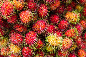 rambutan at organic fruit market in Indonesia. Close up of rambutan fruits (Scientific name: Nephelium lappaceum)