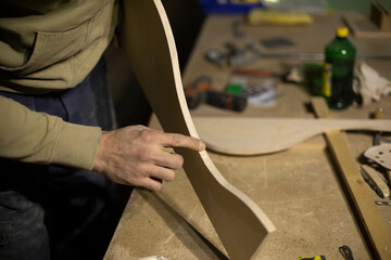 Carpenter holds board. Details of woodwork. Joinery.