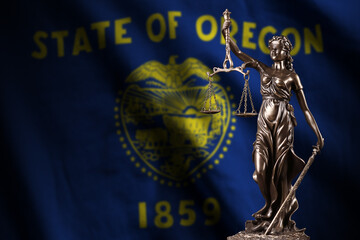 Oregon US state flag with statue of lady justice and judicial scales in dark room. Concept of...