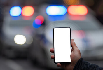 Holding a phone in front of police cars