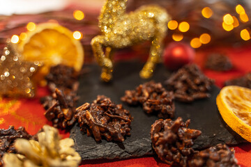 Almond sliver cookies with orange and dark chocolate decorated with a golden reindeer