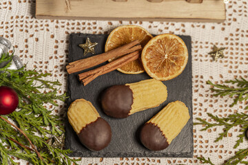 Orange sticks, cookies on a slate with Christmas decorations