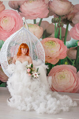 red-haired girl bride. the bride in a white dress with a bouquet