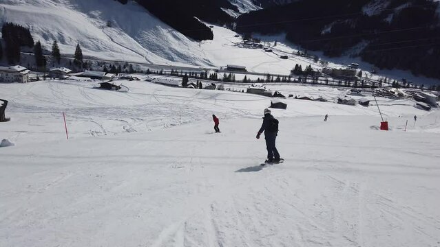 Girl Snowboarder. Perfect snowboarding skills. Girl snowboarding at Mayrhofen in Austrian apls.