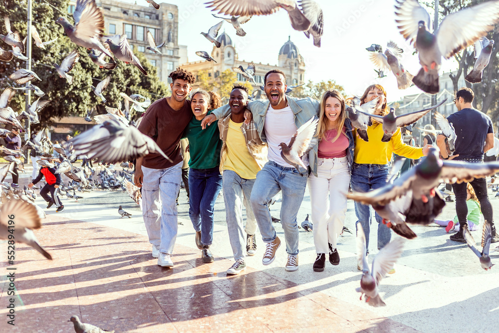 Wall mural multiracial group of young best friends having fun together in barcelona. millennial diverse tourist