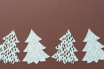 brown paper background with set of holiday trees
