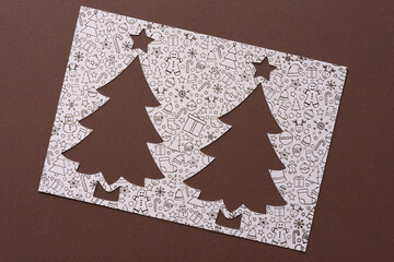 stencil with tree and star cutout on brown