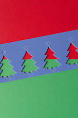 stencils with stylized paper holiday trees on green and red