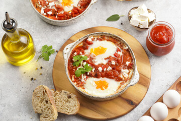Traditional north african dish shakshouka made of eggs poached in a sauce of tomatoes, olive oil, bell peppers, onion and garlic, spiced with cumin, paprika and cayenne pepper